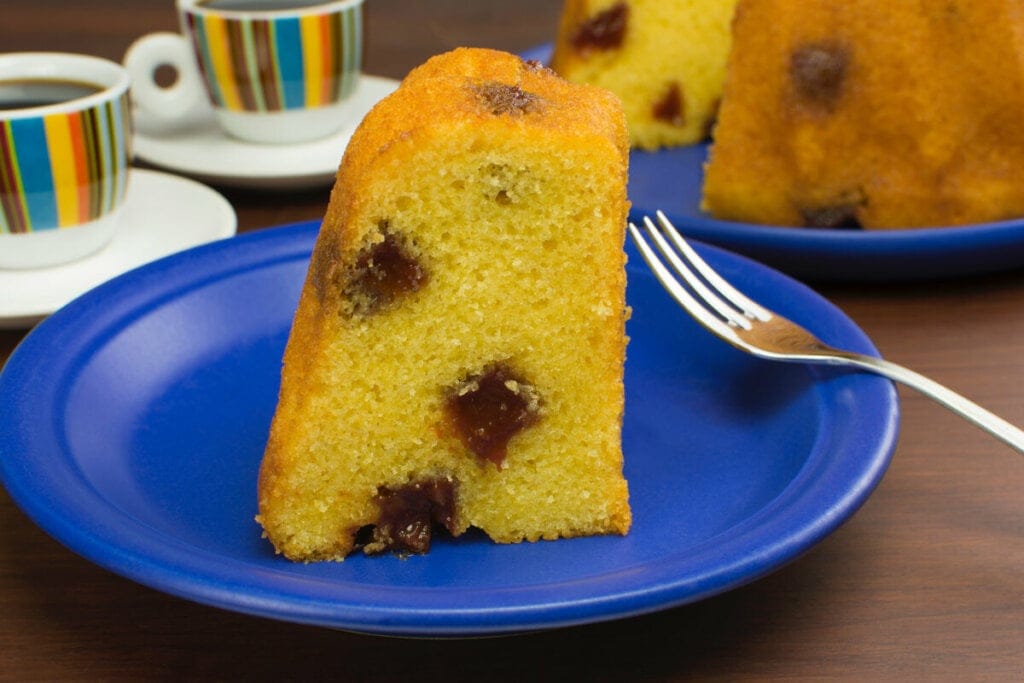 Bolo de fubá com goiabada em cima de um prato azul 
